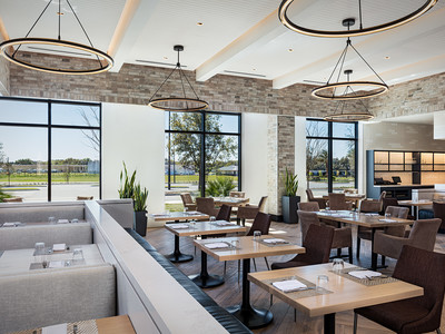 Open, airy seating inside Wolfgang Puck Kitchen + Bar