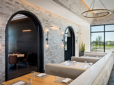 Two arched windows inside Wolfgang Puck Kitchen + Bar