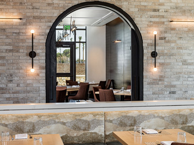 An arched window inside Wolfgang Puck Kitchen + Bar